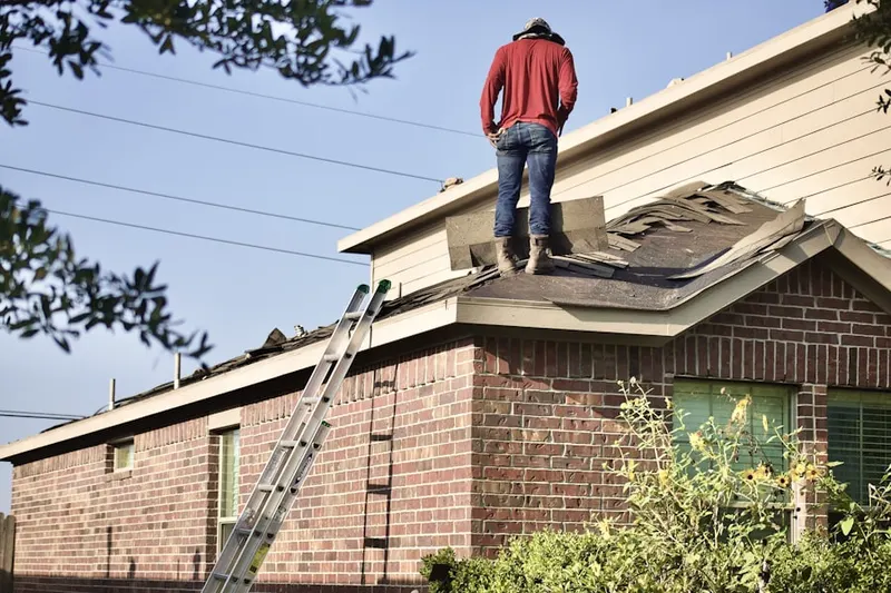Professional roofer working on a residential roof in North Cornwall